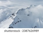 Aerial view of snow mountain range landscape with moving clouds. Alps mountains, Austria