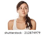 confused young woman posing on a white background