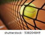 Tennis ball hitting the tennis net on tennis court. Failure concept