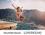 Young Couple Jumping From A...