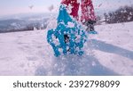 Small photo of LOW ANGLE VIEW, CLOSE UP: Sparkling snow behind a lady running in snowshoes on a nice sunny winter day. Following unrecognizable woman snowshoeing along a snowy meadow in beautiful wintery countryside