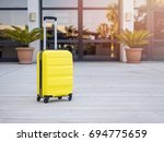 Modern Yellow cabin suitcase in the waiting area in airport
