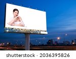 Small photo of Portrait of beautiful charming young Asian woman posing facial and sitting with white table advertise on billboard blank for outdoor advertising poster or blank billboard for advertisement.