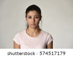 young beautiful hispanic sad woman serious and concerned looking worried and thoughtful facial expression feeling depressed isolated grey background in sadness and sorrow emotion 