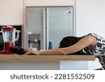Small photo of A woman or girl slumps face-down on her beautiful kitchen table with an empty wine bottle, drunk. Besides being a pitiful and deplorable sight, it's obviously a symptom of pain silenced by addiction.