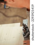 Small photo of Detail in focus of a drilling jig used by the woodworker in his craft workshop. Although they can be self-made the multi-pattern carpenter's drilling jigs are convenient and professional.