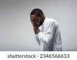 Small photo of depressed young black man struggles with loss or despair. The stigma of mental health in black communities calls for expanded healthcare and information