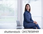 Small photo of The woman's casual yet professional look and thoughtful gaze imply strategic thinking in a relaxed setting