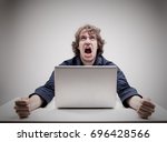 Small photo of angry man swearing and cursing against information technology and his compuiter worries and hassles - concept of hating computers