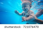 Small photo of Baby background. Happy infant learn to swim, dive underwater with fun in pool to keep fit. Diving.