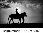 Silhouette of child riding...