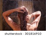 Woman in the shower, back side of young female showering under refreshing water, healthy lifestyle, enjoying time in luxury spa resort 
