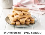 Italian cookie savoiardi. Sweet biscuits. Sponge cookies tiramisu on white table.