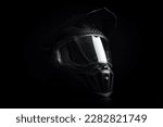 Black carbon motorcycle helmet. Offroad motocross helmet with shieldon the black background.