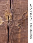 Small photo of Wooden pine beam with a crack painted by stain. Macro texture background. Spile bitch with drops of rosin