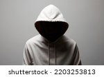Small photo of Man in Hood. Boy in white hooded sweatshirt. Incognito person