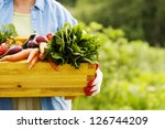 Senior woman holding box with vegetables