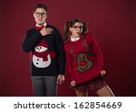 Crazy nerd couple in funny sweaters goofing around