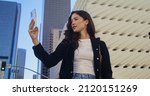 Small photo of Attractive asian lady take picture high urban buildings using smartphone close up. Confident young woman raise hand with phone making photo cityscape. Modern technology in nowaday people life.