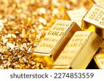 Small photo of Gold bars on nugget grains background, close-up