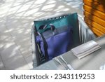 Small photo of a bag abandoned on a chair in cafeteria, outdoor shot, concept of obliviousness