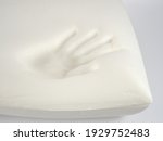 Small photo of Orthopedic pillow, memory foam. Handprint on the pillow. Comfortable bedding with orthopaedic, therapeutic effect. Memory foam material.