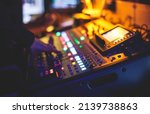 Small photo of View of lighting technician operator working on mixing console workplace during live event concert on stage show broadcast, light mixer controller panel, sound technician with professional equipment