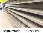 Small photo of View of empty supermarket shelves, grocery store work stoppage closes, sanctions and embargo, panic buying with supplies and goods shortage, food crisis and deficit concept