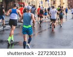 Small photo of Marathon runners crowd, participants start running the half-marathon in the city streets, crowd of joggers in motion, group athletes outdoor training competition