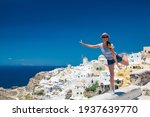 Beautiful white exterior Santorini. Architecture of island, the most romantic island in the world, Greece.  Luxury holiday at the hotel near the sea.  Travel to Greece. Girl tourist