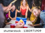 Small photo of Young friends playing beer pong at youth hostel - Free time travel concept with backpackers having unplugged fun at guesthouse - Happy people on playful genuine attitude - Vivid vignetting filter