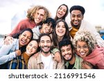 Small photo of Multi ethnic guys and girls taking selfie outdoors with backlight - Happy life style friendship concept on young multicultural people having fun day together in Barcelona - Bright vivid filter