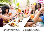 Small photo of Trendy friends drinking cocktails at poolside party - Young people having fun on luxury resort - Fancy life style concept with guys and girls toasting drinks and fruit together - Bright vivid filter