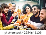 Small photo of Trendy friends toasting spritz cocktail at bar restaurant - Life style concept with young people having fun together sharing drinks on happy hour at garden party - Vivid contrast filtered color tones
