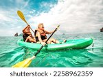 Small photo of Happy retired couple enjoying travel moment paddling on kayak at Angthong marine park in Ko Samui in Thailand - Active elderly concept around world nature wonders - Bright vivid filtered tone