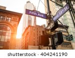 Street sign of Fifth Ave and West 33rd St at sunset in New York City - Urban road concept direction in Ny Manhattan downtown - American world famous capital destination on warm dramatic filtered look