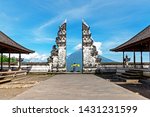 Unidentified Woman at Gate at Pura Lempuyang Luhur with Mr Agung Volcanic View, sacred Hinduism temple in Bali Indonesia. 