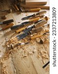 Small photo of Timber, wood processing. Joinery work. Wood carving with work tools close up. Hand of carver carving wood. Craftsman carving with a gouge