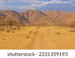 Namibian landscape. African savannah during a hot day.Red ground. Solitaire, Namibia.