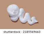 Shaving cream isolated on brown color background.