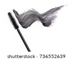 Black mascara brush stroke with applicator brush  isolated on white