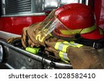 Firefighter gears on the bumper of the fire truck