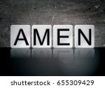 The word Amen concept and theme written in white tiles on a dark background.