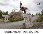 Small photo of FREDRIKA, SWEDEN ON JUNE 27. The Buddha Rama Temple on the top on June 27, 2014 in Fredrika, Sweden. A bronze monk and the Buddha statue. Flowers and elephants this side.