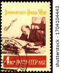 Small photo of Moscow, Russia - April 14, 2020: stamp printed in USSR (Russia), shows Vladimir Lenin reading the newspaper Pravda in his office in Kremlin, circa 1962