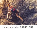 Athletic Woman Rock Climbing At ...