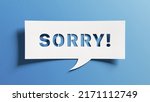 Small photo of Sorry message to express regret, remorse, apology for error, mistake, guilt and request forgiveness. Concept with word written in cut out paper in shape of speech bubble with blue background.
