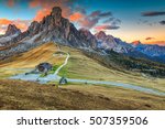 Fantastic autumn landscape,alpine pass and yellow pine trees,Passo Giau with famous Ra Gusela,Nuvolau peaks in background,Dolomites,Italy,Europe