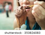 Woman hand holding chocolate ice cream cone