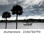 A Sailboat In The Harbor With...